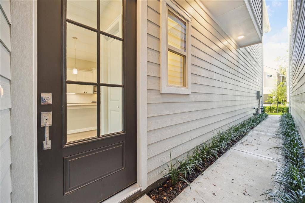 Beautiful landscaped walkway to the front door entry. French front door with leaded glass inserts.