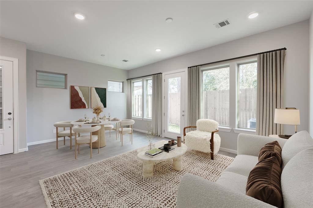 Combined and flexible living and dining spaces overlooking private back yard has many windows and French door bringng in natural light. (virtually staged)