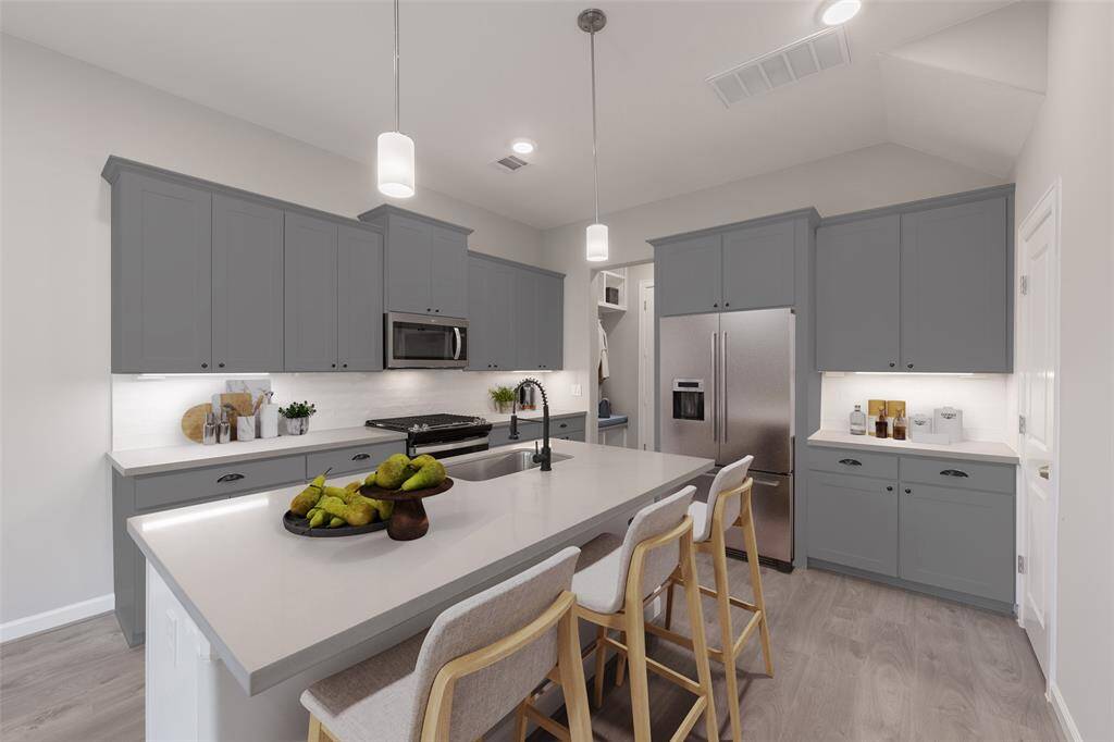 Kitchen has expansive quartz counter tops and a separate counter for specialty use such as a dry bar or a coffee bar. (virtually staged)