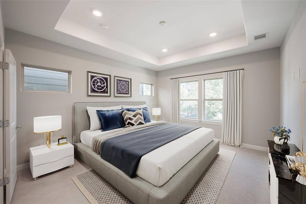 Gorgous primary bedroom has raised ceiling and many windows to bring in natural light. (virtually staged)