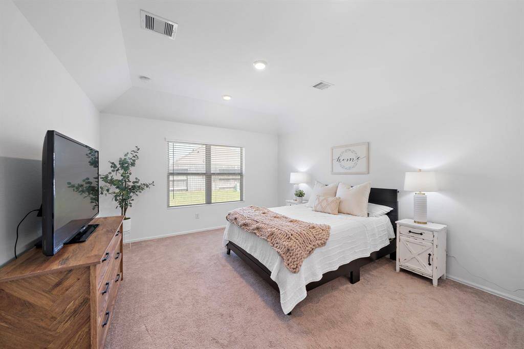 The primary bedroom is bright and spacious, with an abundance of natural light.