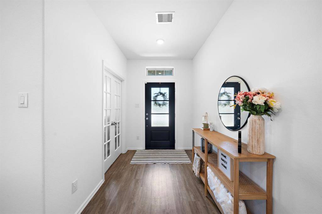 The home has a bright and welcoming entryway! Notice the set of French doors on the left, which adds elegance and charm.