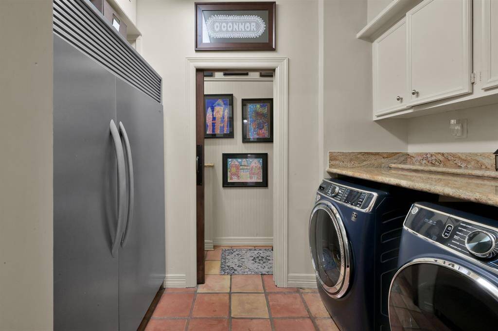 The laundry room has space for a full sized refrigerator and full sized freezer, and has granite counters over the washer and dryer.