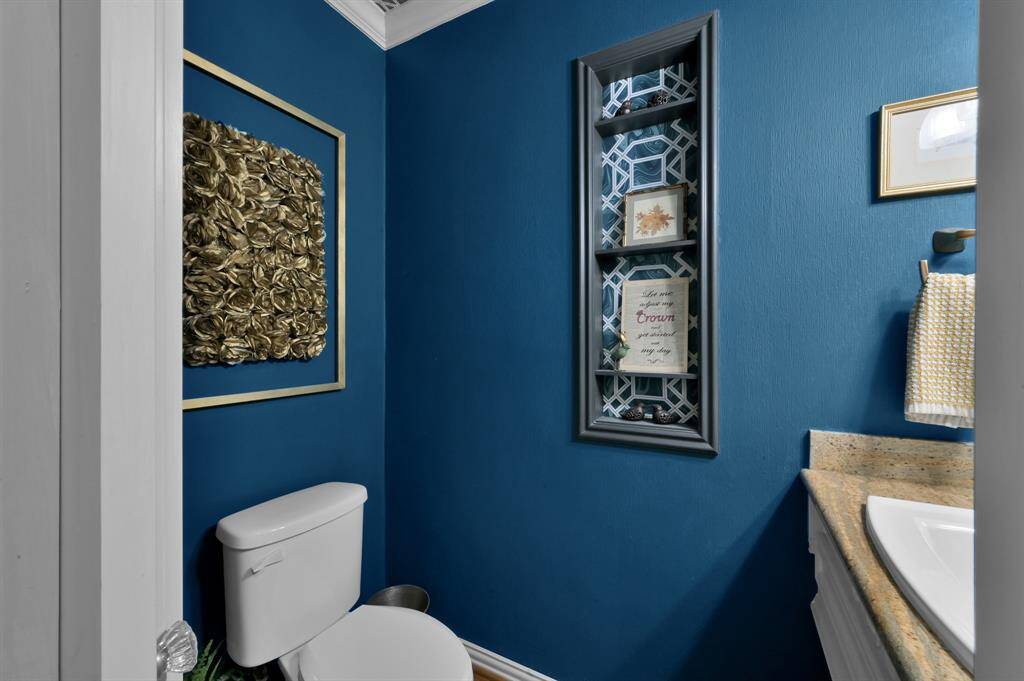 This little jewel box in the back hall: a deep blue powder room that has the accent paper on the ceiling not the walls.  Hello Architectural Digest!