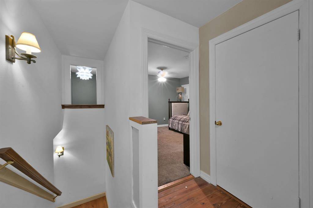 Bedroom 5 from the back stairs highlighting the Juliet window in the walk-in closet entry.