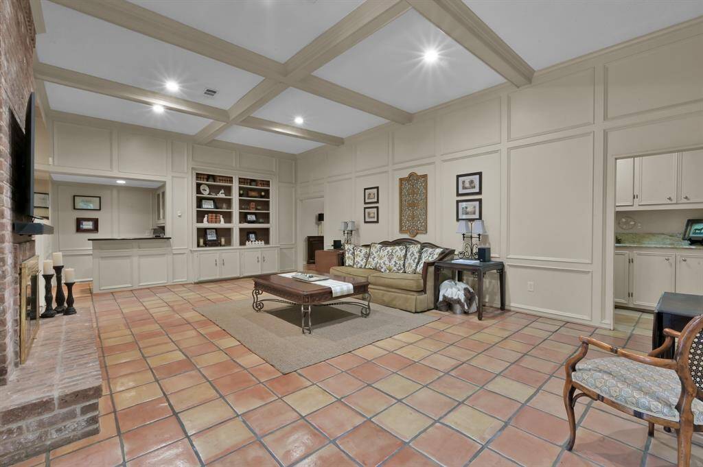 Main living space viewed from the breakfast room. Look at the beautiful block paneling, built in bookcase, wet bar,  and the doorway into the Butlers Pantry.