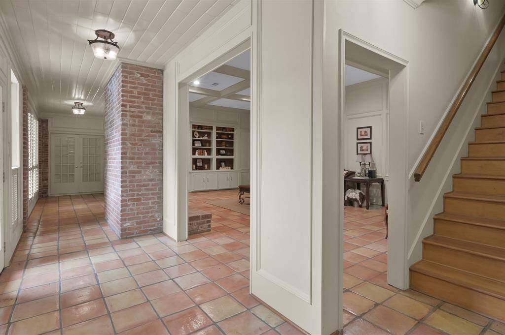 Another view of the loggia and the kitchen stairs.  So classic with the tongue and groove ceiling and the exposed fireplace.