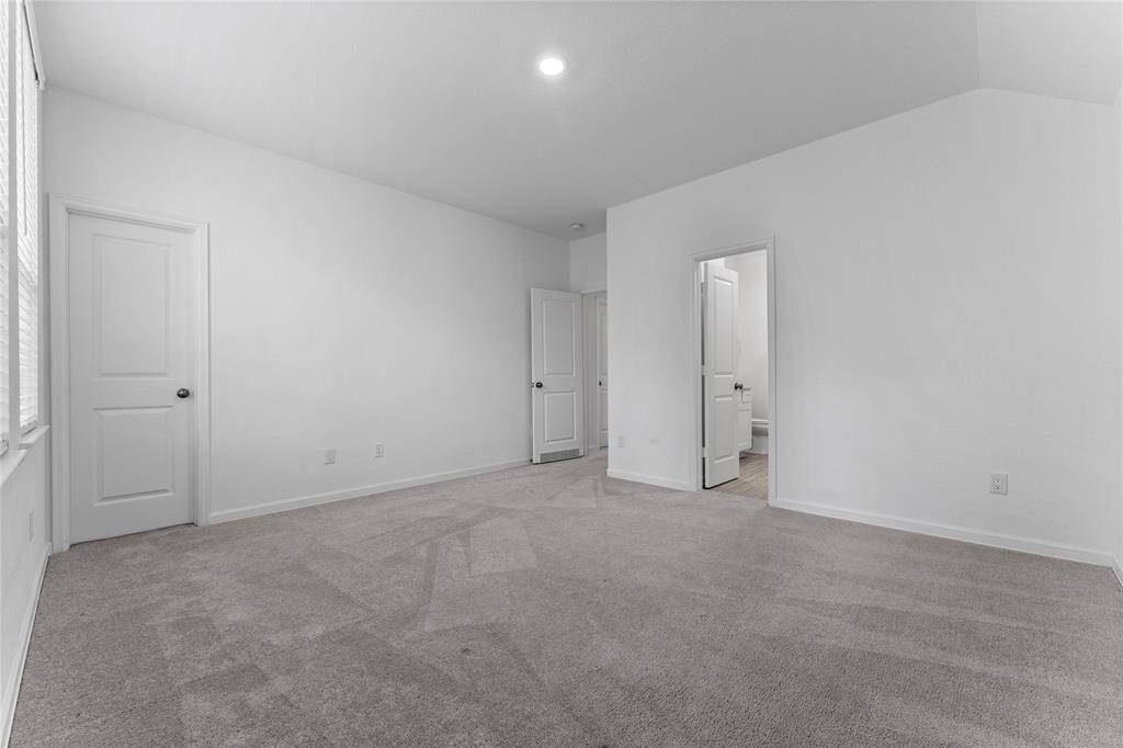 Another view of this secondary bedroom showing the walk-in closet and the entrance to the Hollywood bath.