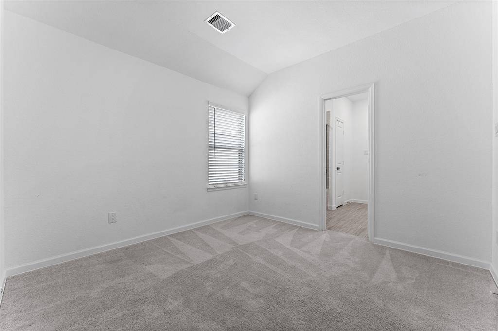 Another secondary bedroom offers lush carpeting, sloped ceiling, extra-deep wall closet, sunny window with blinds, and ceiling light. It has direct access to a Hollywood bath shared with Bedroom 2.