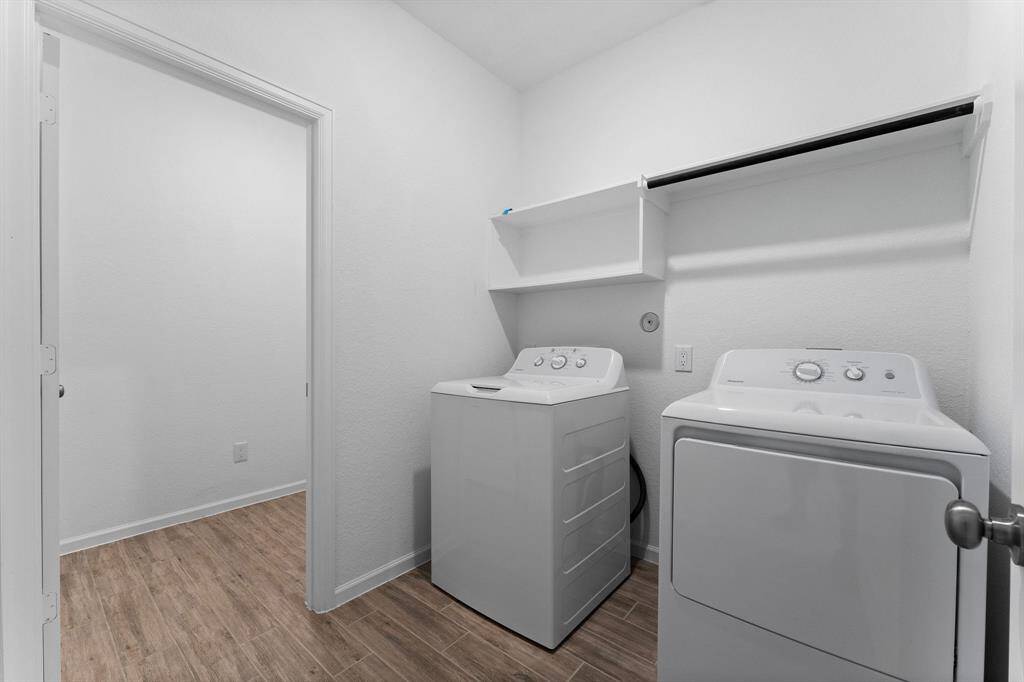 Large laundry room is conveniently located on the second floor and boasts wood-look tile flooring, ample shelving, and an auto-timer light. This room also boasts an additional storage area with door. Washer and Dryer included.