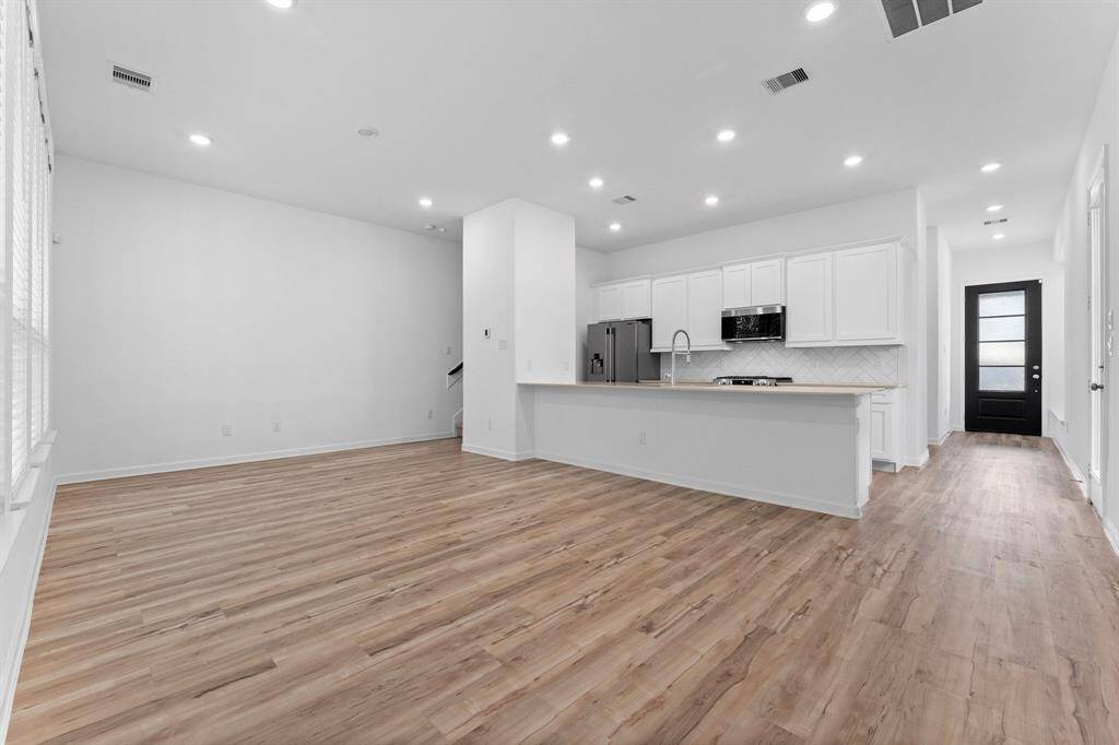 Great view of this home’s elegance looking toward the kitchen.  You will love this open concept floorplan that makes family living easy and is a dream for entertaining.