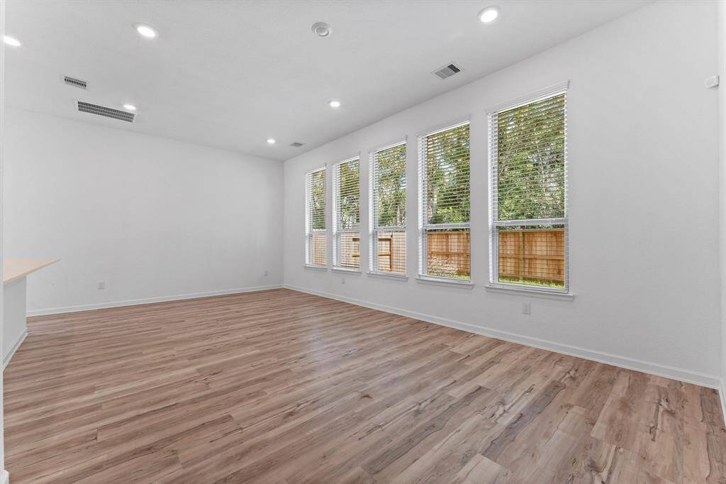 Enjoy panoramic backyard views from the spacious dining area! Perfectly positioned between the kitchen and living room, this light-filled space is lined with windows that frame stunning views of the backyard—ideal for everyday meals or entertaining guests.