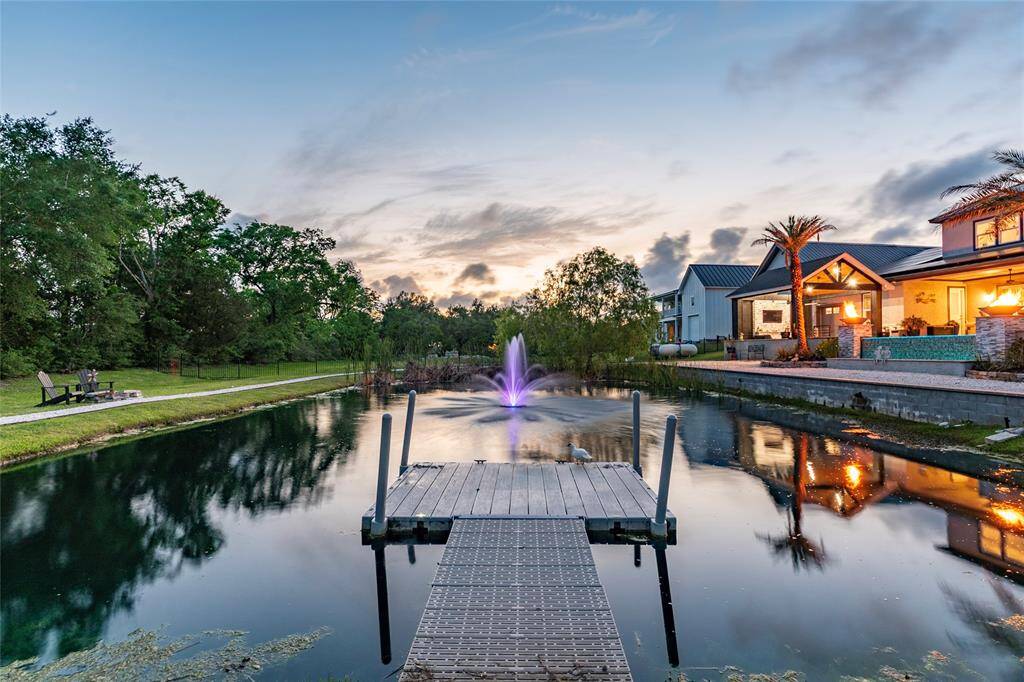 Nature lovers will be captivated by the fully stocked pond, complete with a professionally installed dock, a lighted fountain, fire-pit and a scenic walking trail encircling the water. Perfect for peaceful morning fishing or enjoying golden sunsets reflected on the water’s surface—this serene retreat offers a daily dose of natural beauty and relaxation.