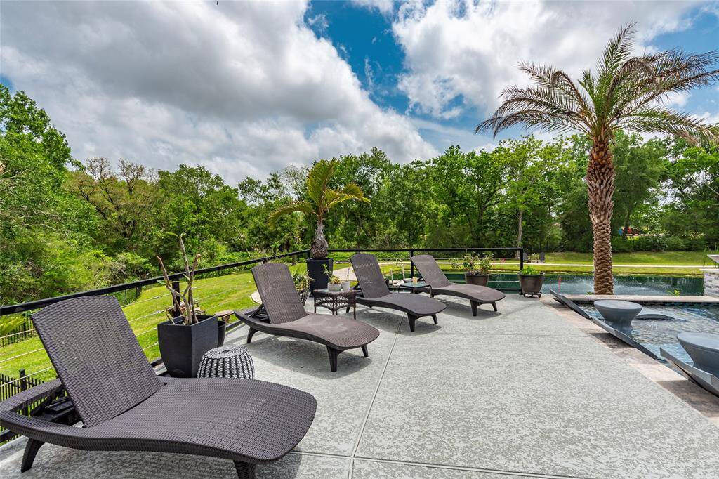 A sprawling 450 sq. ft. Spray Cool deck offers the perfect space for sunbathing and unwinding, all while overlooking the serene infinity-edge pool, tranquil stocked pond, and expansive backyard. Surrounded by meticulously manicured landscaping and maintained effortlessly with a full sprinkler system, this outdoor haven is designed for both beauty and relaxation.