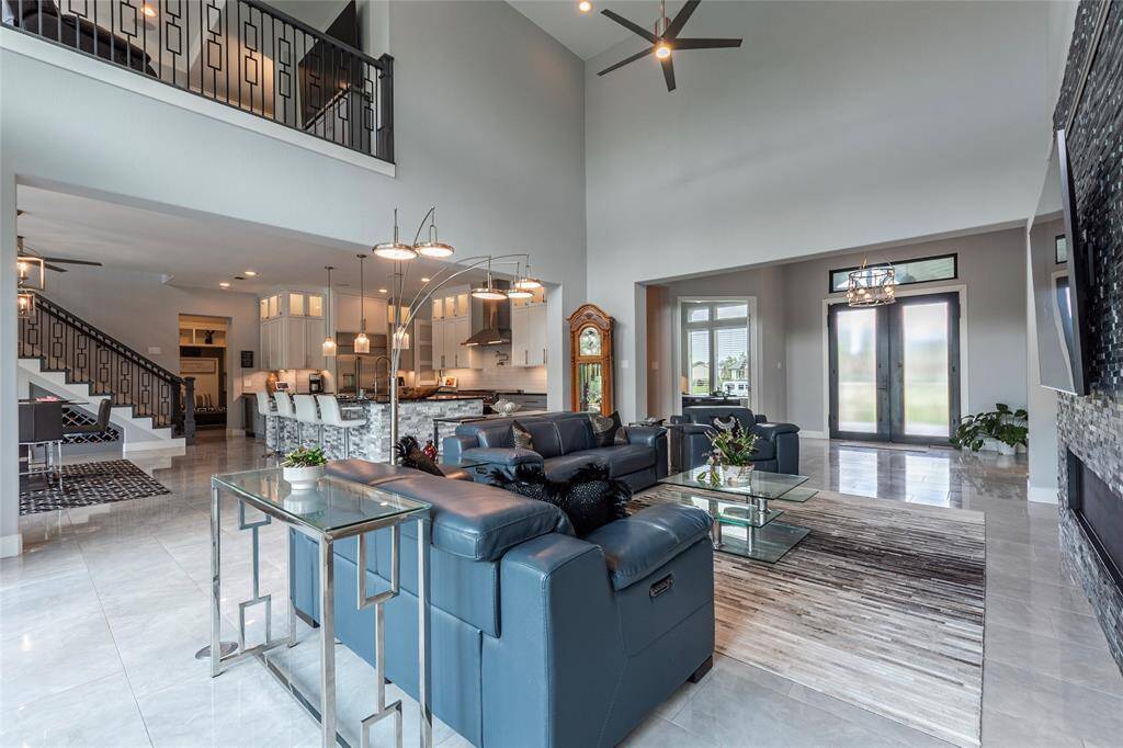 Another view of the spacious living room reveals its open-concept design, seamlessly connecting to the kitchen and dining areas for effortless flow and interaction.