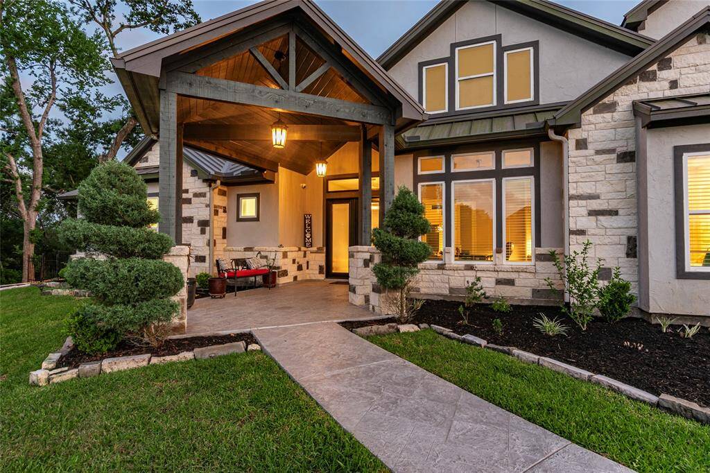 Welcoming front porch and grand entryway are complemented by lush, professional landscaping with a full sprinkler system. Enhanced security includes outdoor cameras and a monitored entry system for peace of mind.