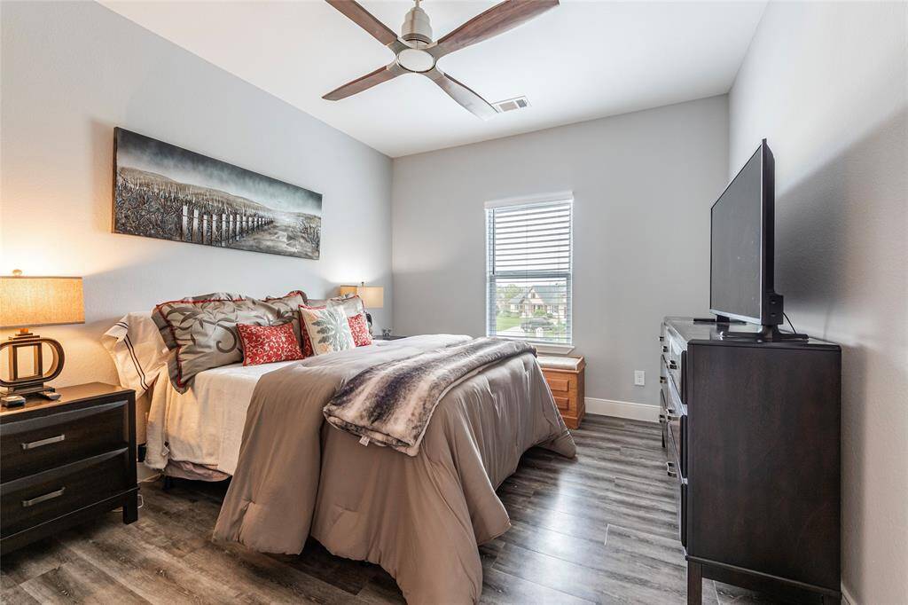 The third bedroom upstairs offers ample space, front-yard views, and a walk-in closet, conveniently located next to a full bathroom with a tub/shower combination.