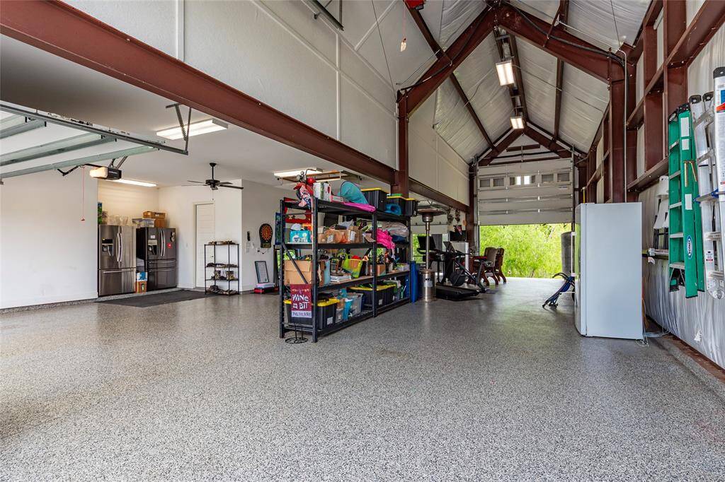 The impressive 2,000 sq ft RV garage, 16+ ft high x 59.5-ft in length, features an automatic Attic Storage Lift for convenient storage options, extended durable epoxy flooring and dual bay doors at the front and rear for easy access. This luxury custom home is fully equipped for off-the-grid living, featuring a water well, aerobic septic system, and a propane-powered emergency generator—delivering comfort, security, and independence without compromise.