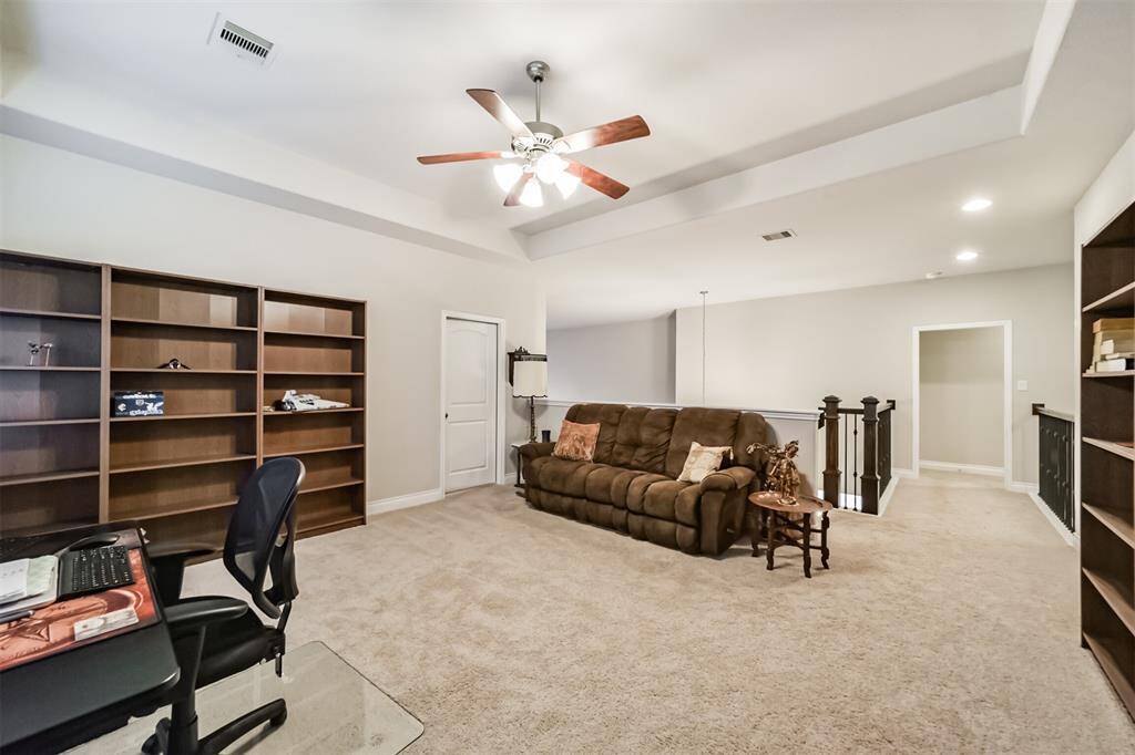 The spacious landing on the second floor is essentially your game room. Offering plenty of room for pool table, shuffleboard or as it is currently as as secondary office space. The door to the left opens to a private media roo, that can be customized to your liking.