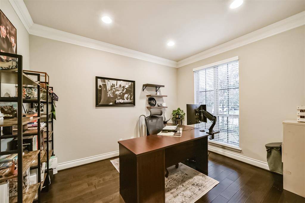 Overlooking the front yard, you'll enjoy a spacious home office with dual French doors for privacy.