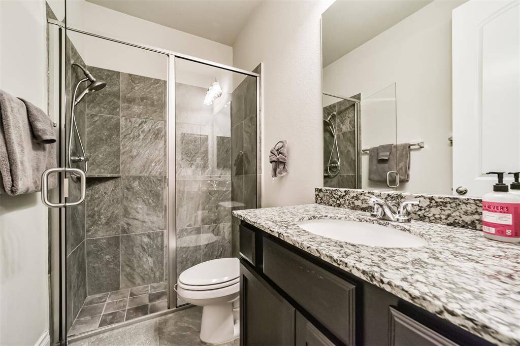 The en-suite bathroom serving the first floor bedroom. nice walk-in shower and ample counterspace.