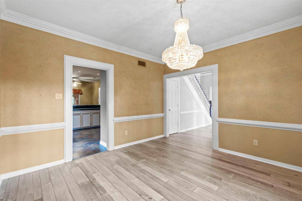Another view of the dining room off of the entry with access to the kitchen. Look at that beautiful chandelier!