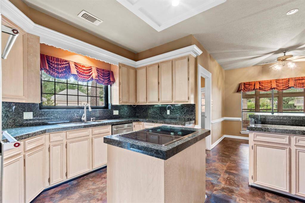 This kitchen has granite counter tops, stainless steel dishwasher, stainless steel double convection ovens, and vinyl floors- tongue and groove impact absorbing.