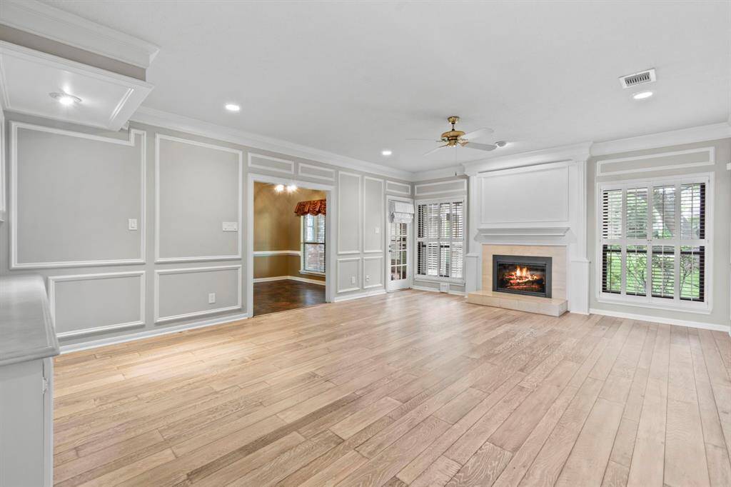 This huge living room with engineered hard wood floors, neutral paint/white details is ready for your largest living room suit! Gas log fire place, windows looking out to the huge back yard and open to the breakfast room.