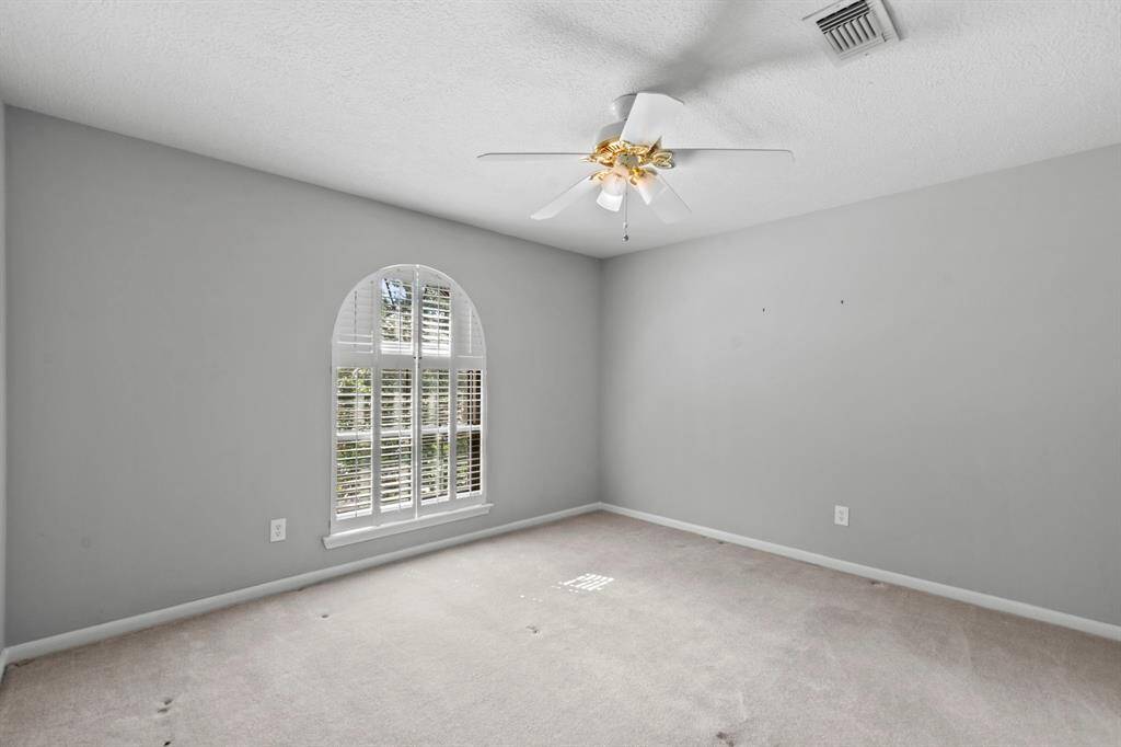 This secondary bedroom looks out to the front of the house.