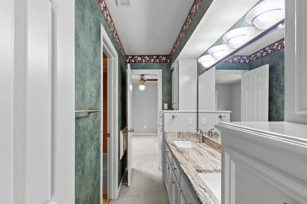 This Jack and Jill has beautifully updated countertops, sinks, hardware, lighting and fixtures!