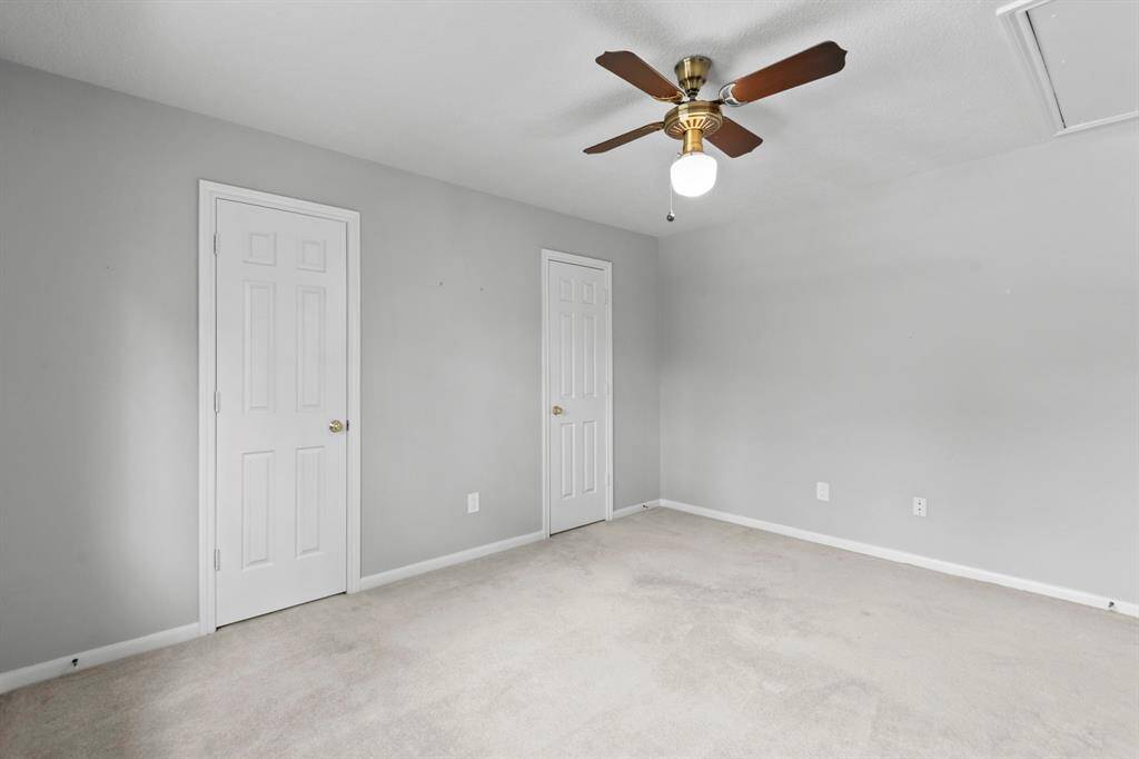This is the other secondary bedroom upstairs that shares the Jack and Jill bath. Two closets, ceiling fan, neutral paint.