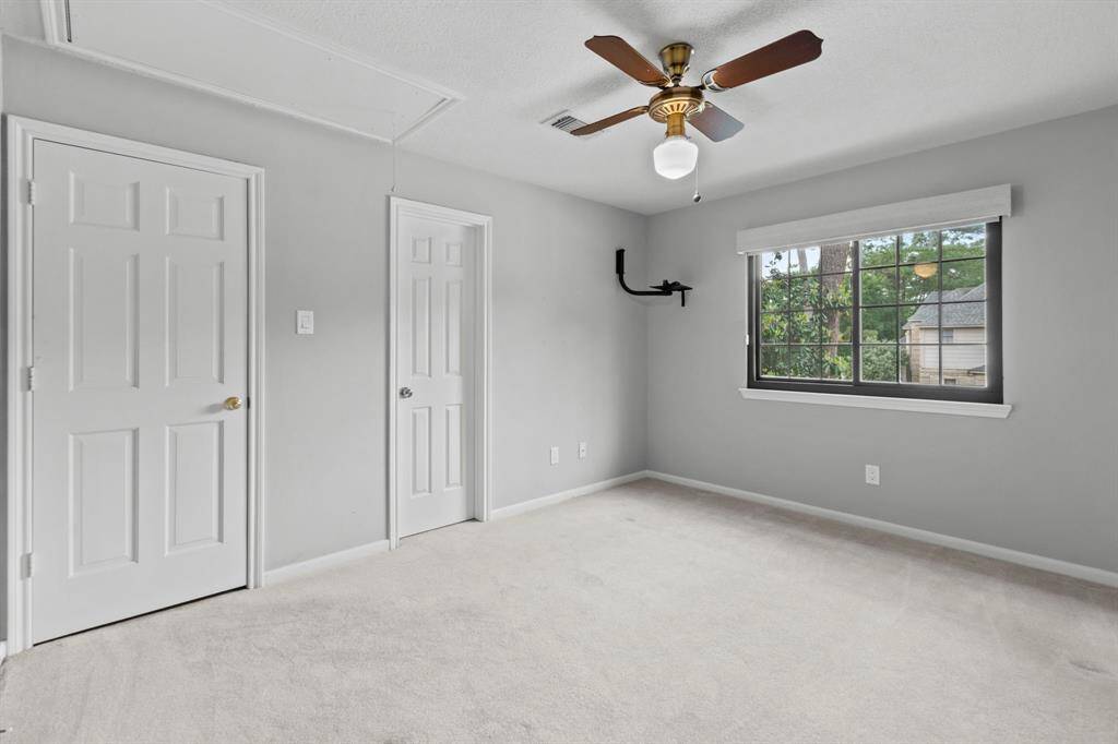 Another view of this secondary bedroom on the second floor- great window with an updated rolling shade.