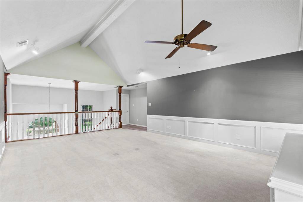 Another view of this huge game room. Ceiling fan, natural light pouring in, updated paint and lighting.