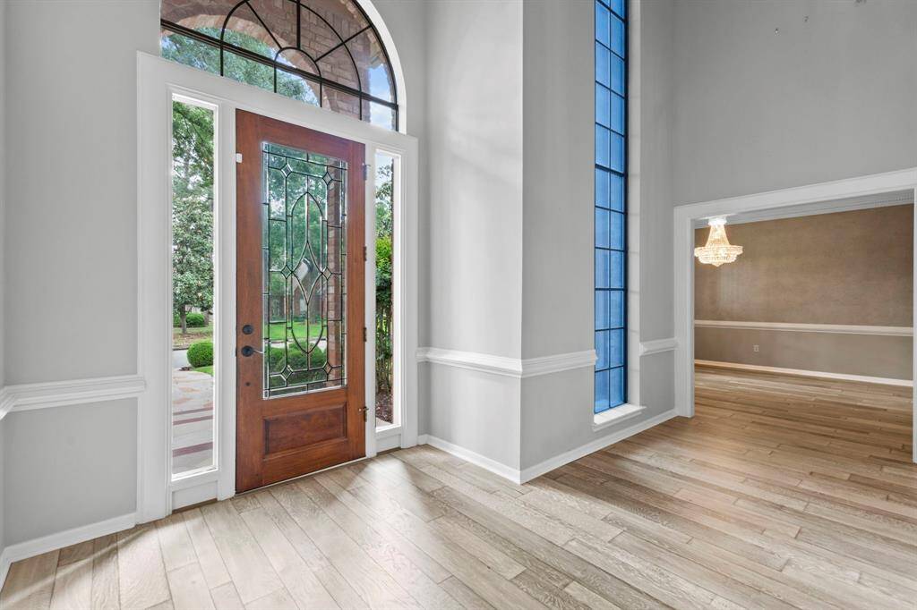 Let's go inside! This gorgeous two story entry greets you with neutral paint, white trim and crown molding- plus recently installed engineeered hard wood floors!