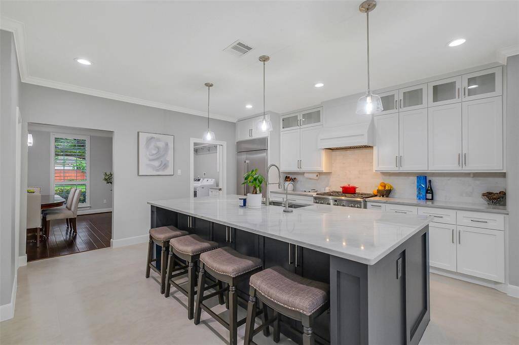 Impeccably tailored gourmet kitchen featuring custom cabinetry, designer hardware, and high-end appliances—where culinary artistry meets elegant design.