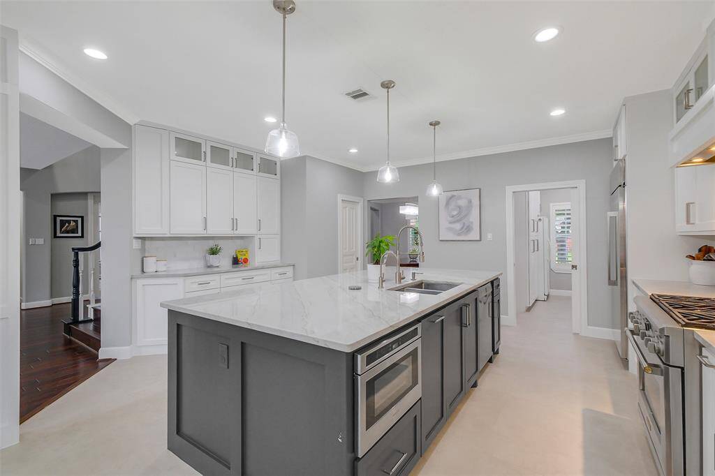 The heart of the home, this gourmet kitchen balances beauty and function with premium appliances, a spacious center island, and curated finishes that exude understated luxury.