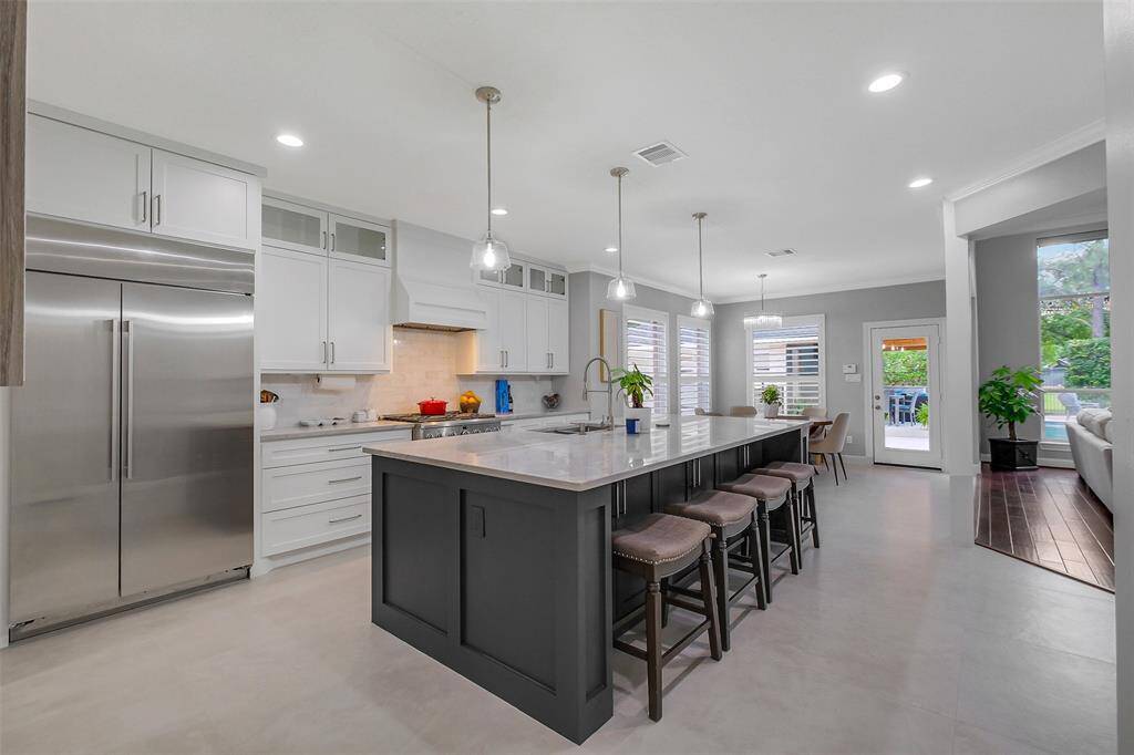 A seamless blend of classic charm and modern refinement, this kitchen showcases warm tones, elegant hardware, and impeccable craftsmanship throughout.