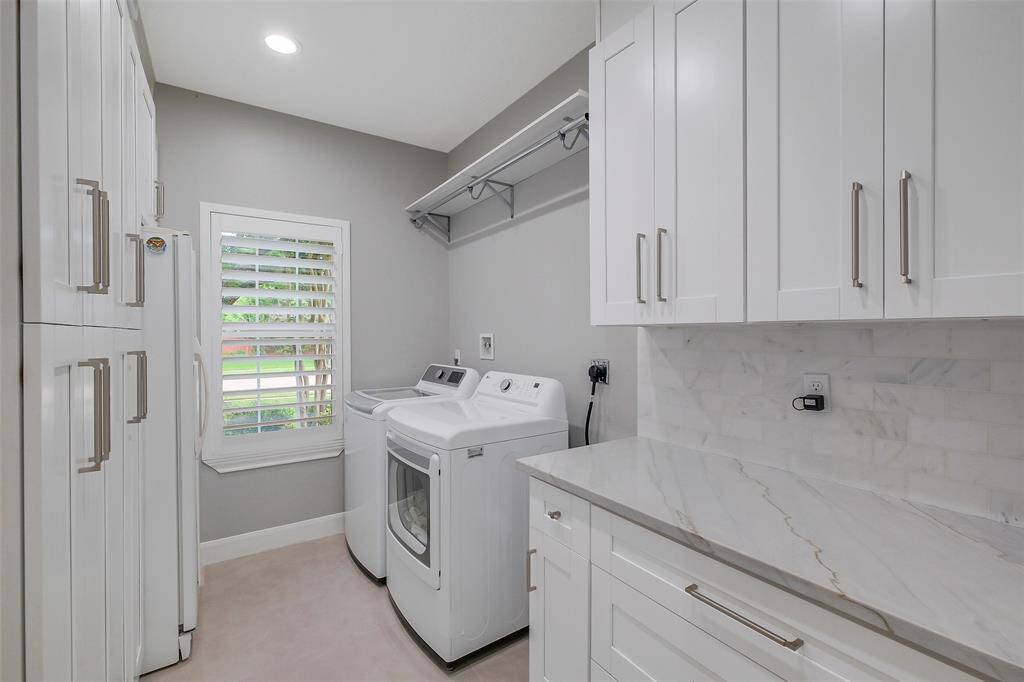 An exquisite open-concept kitchen flows effortlessly into a sunlit breakfast area, where refined finishes meet everyday comfort—perfect for morning coffee, casual gatherings, or quiet moments framed by graceful design.