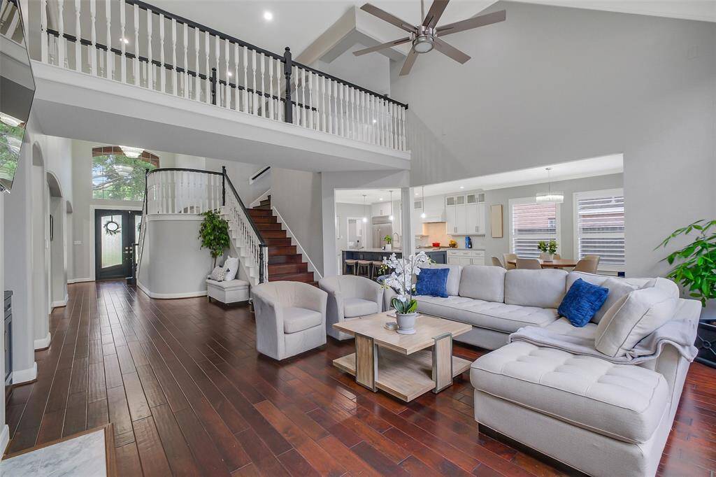 Bathed in natural light, this elegant living area offers soaring ceilings, timeless architectural accents, and seamless indoor-outdoor flow—perfect for refined entertaining.