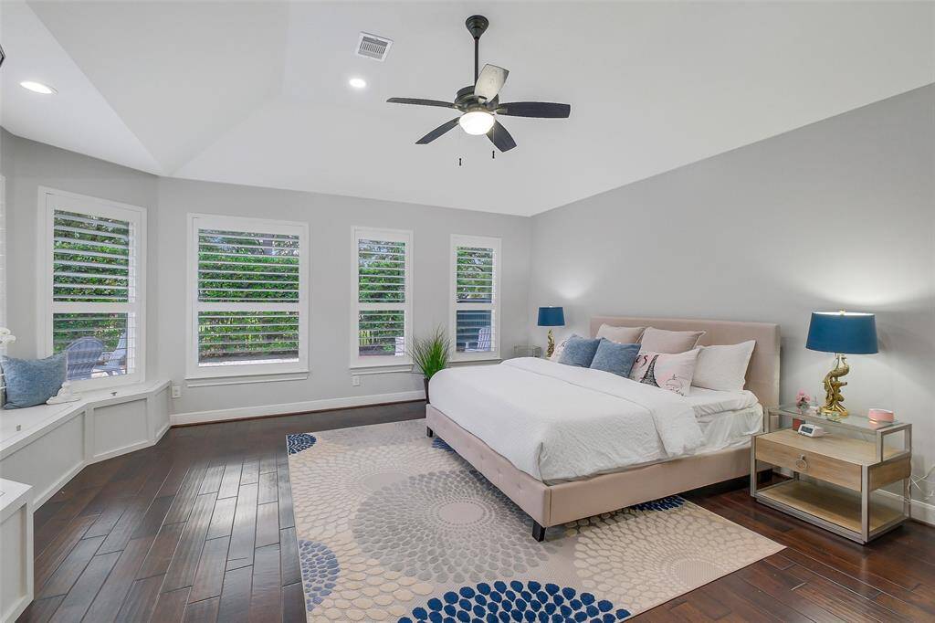 The spacious primary bedroom is a serene sanctuary, offering a perfect blend of luxury and comfort. With expansive windows that flood the room with natural light, the space is designed for relaxation, featuring rich hardwood floors and designer finishes. The ensuite bathroom and walk-in closet provide a seamless connection to the room, elevating the sense of tranquility and convenience. It’s the ultimate retreat for rest and rejuvenation.