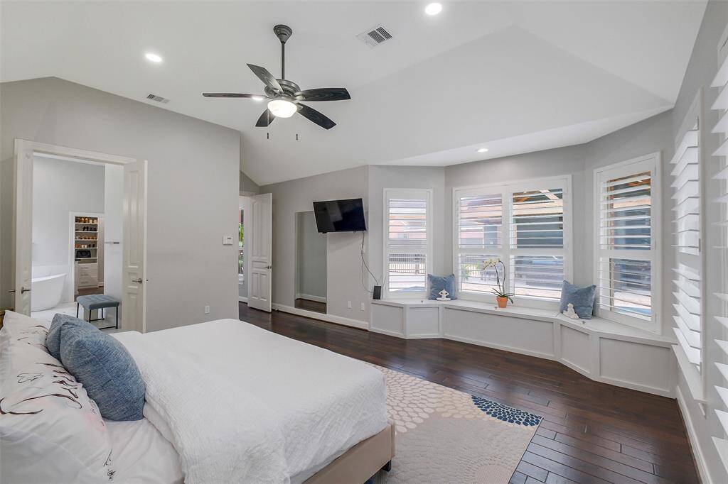 This exquisite primary bedroom is bathed in natural light, thanks to a stunning set of bay windows that offer sweeping views and create a serene reading nook. The spacious layout is complemented by rich hardwood floors and elegant finishes, making it the perfect sanctuary for relaxation. With ample closet space and a luxurious ensuite, this room combines both comfort and sophistication, providing a tranquil retreat that feels like a personal getaway.