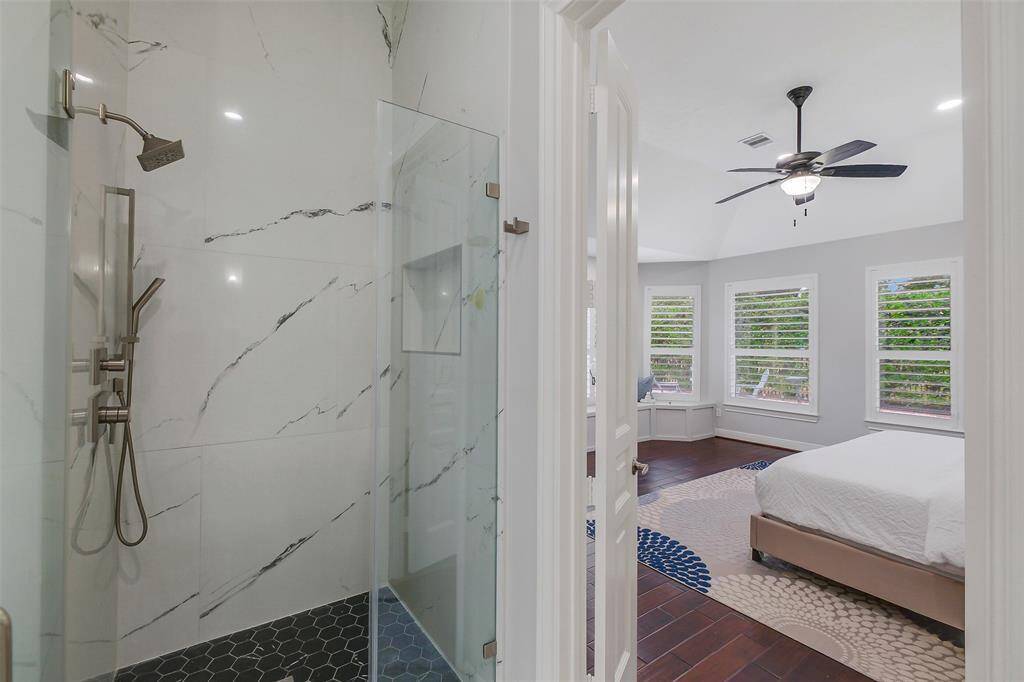 This beautifully appointed primary bathroom offers a sense of calm and luxury, featuring elegant dual sinks with custom cabinetry and sleek countertops. The spacious layout ensures both functionality and style, with ample storage and designer fixtures throughout. A perfect blend of convenience and sophistication, the bathroom provides an ideal setting for relaxation and everyday indulgence.