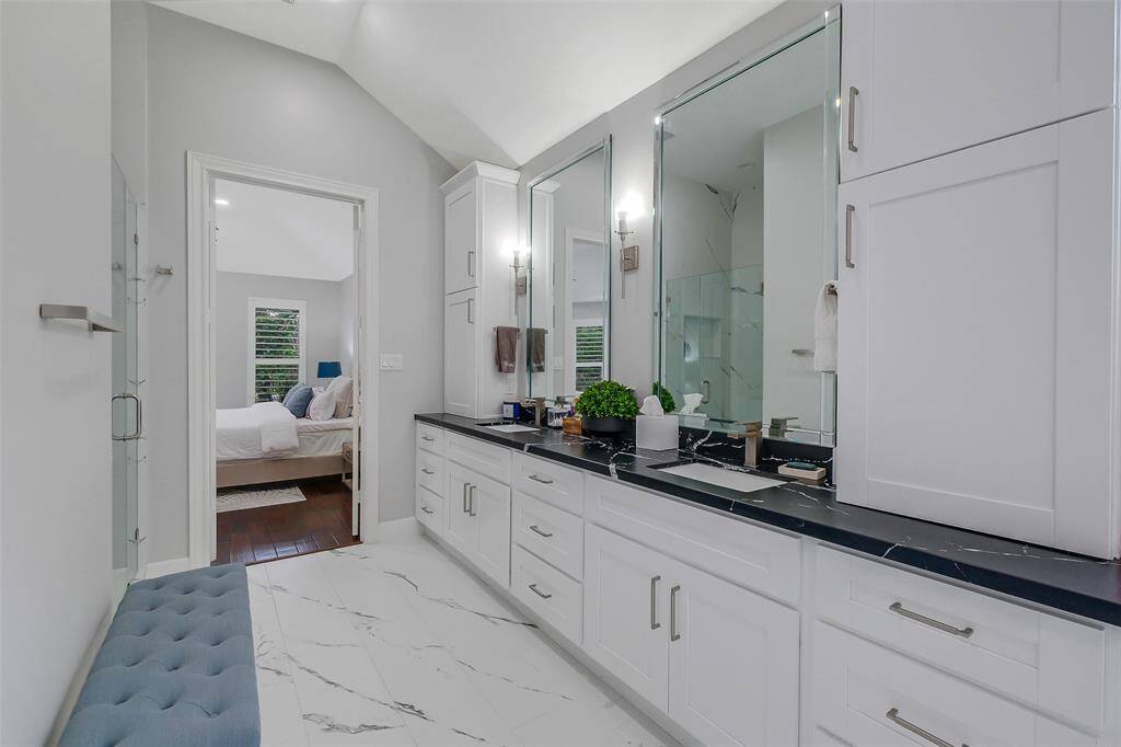The expansive master closet is a true wardrobe haven, offering custom-built shelving, hanging spaces, and a thoughtful layout that ensures both style and functionality. With ample room for all your finest pieces, it provides a seamless combination of organization and luxury. The beautifully crafted cabinetry and sleek finishes elevate the space, making it feel like a private boutique for your belongings.