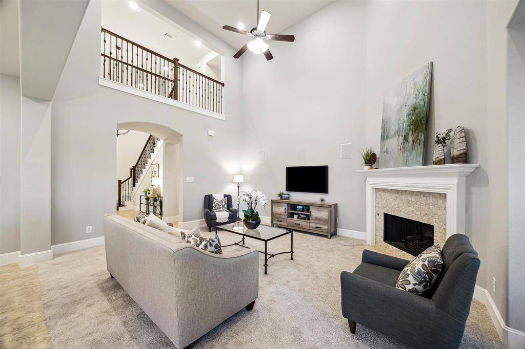 Warm up by the inviting fireplace with ample space for your dream entertainment setup.