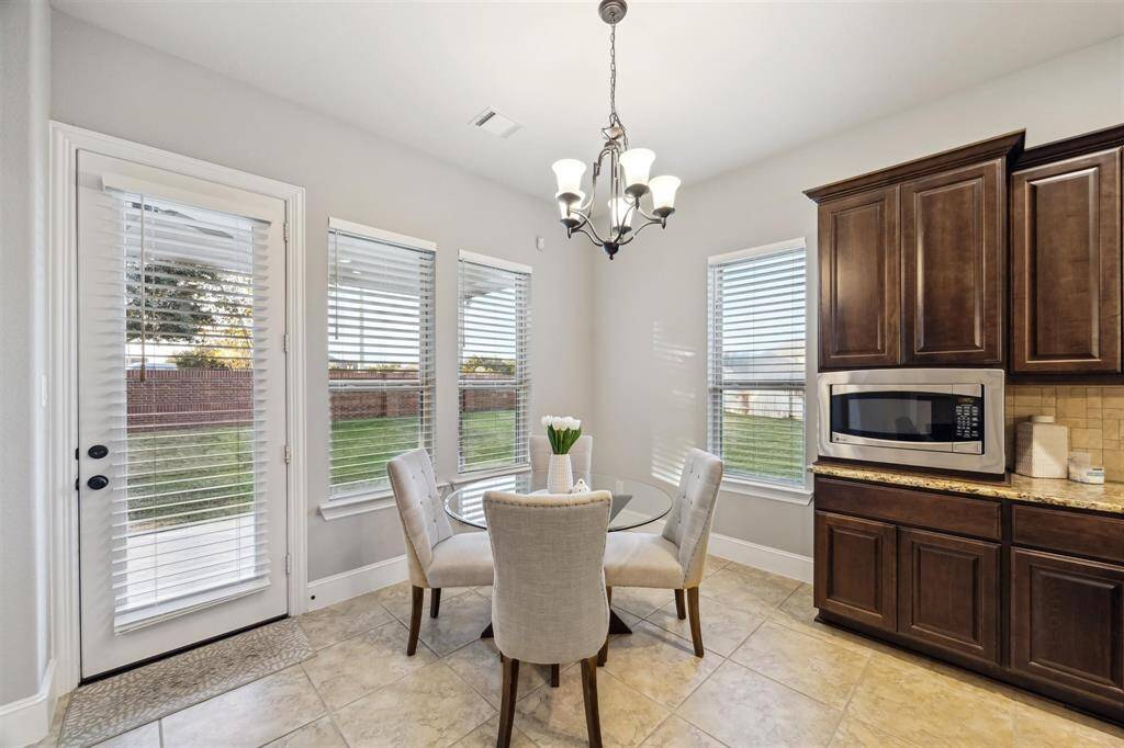 Cozy breakfast nook with abundant natural light and backyard views—perfect for morning coffee.