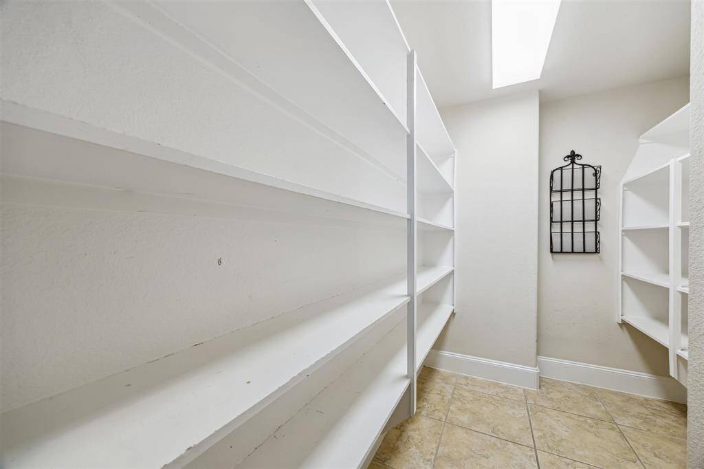 Spacious walk-in pantry for all your storage needs.