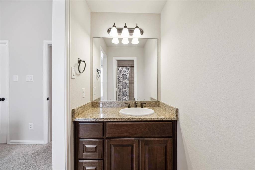 Spacious Jack and Jill bathroom with modern fixtures, dual access, and elegant tile accents. Perfect for shared convenience.