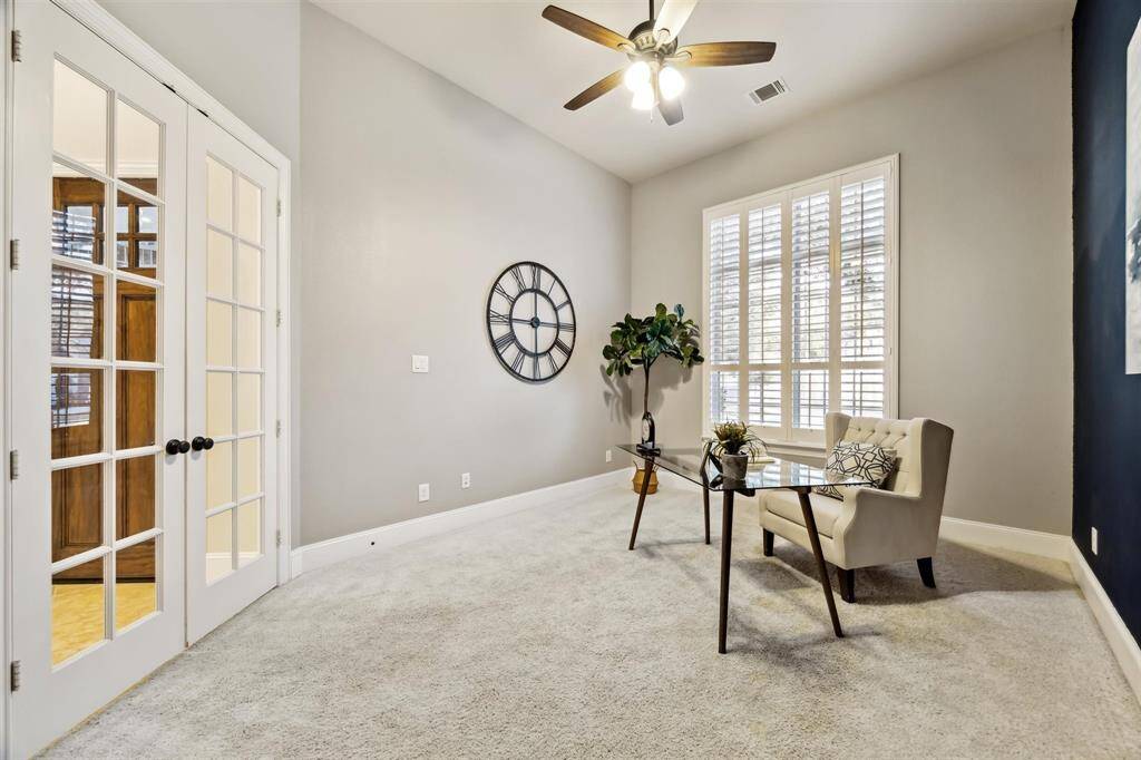 Elegant office featuring French doors for a touch of sophistication and ample space for productivity.