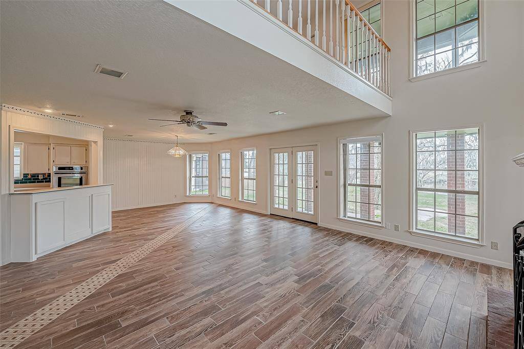 Floor-to-ceiling glass fills the living spaces with natural light, blurring the lines between indoors and out. Glass-paneled double doors open to the outdoors, extending the living space beyond the walls of the home.