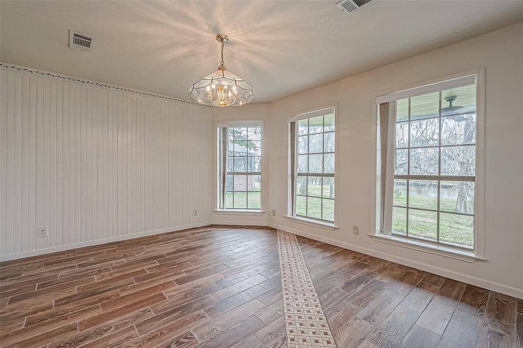 The dining area’s large windows take center stage, offering a beautiful backdrop for every meal. Whether enjoying morning coffee or hosting dinner, this bright and airy space enhances every occasion.